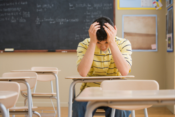 Frustrated Teenage Boy in Classroom