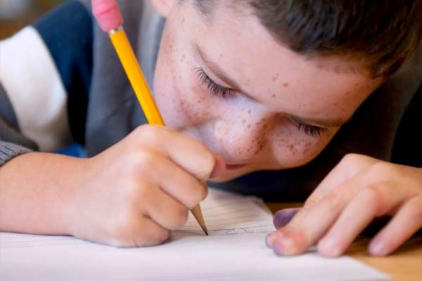 boy-writing-with-pencil